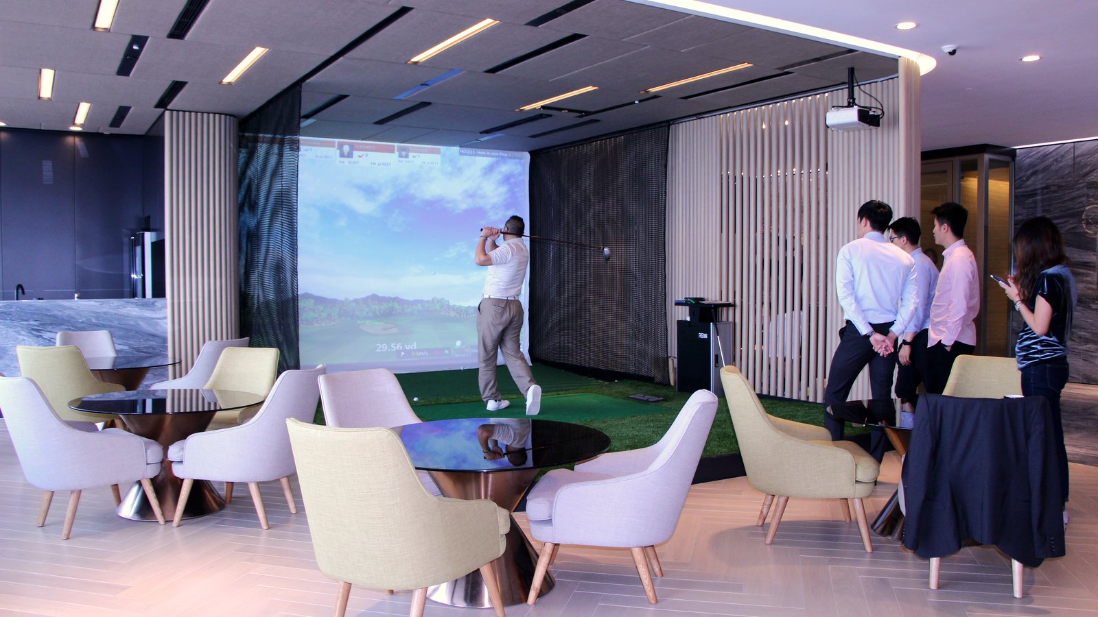 Indoor golf simulator bay in a corporate lounge